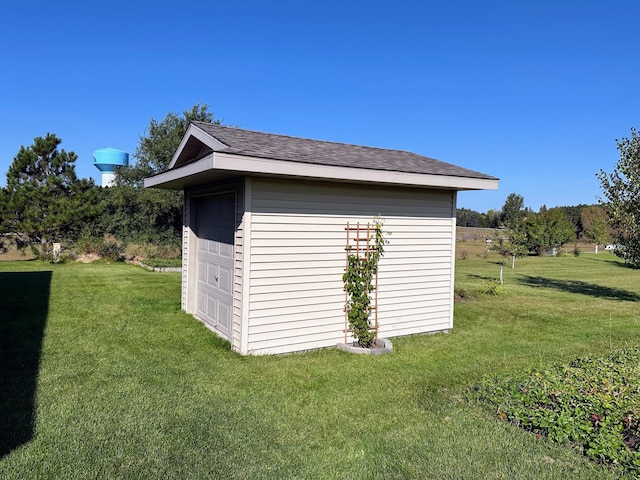 view of outbuilding with a lawn