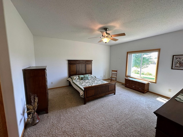 unfurnished bedroom featuring a textured ceiling, light colored carpet, and ceiling fan