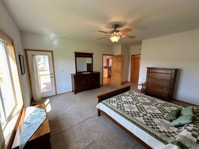 bedroom with a textured ceiling, access to outside, carpet floors, and ceiling fan