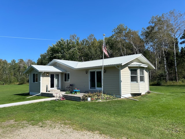 ranch-style home with a front lawn and metal roof