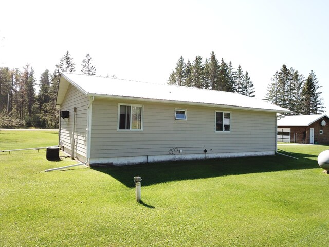 back of property featuring a lawn