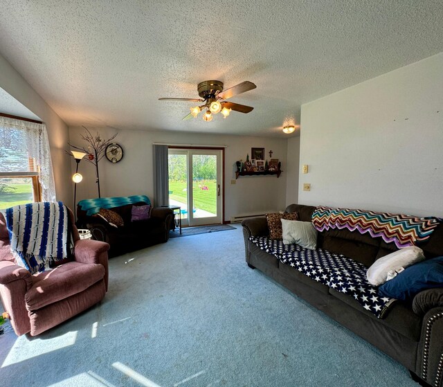 living room featuring a textured ceiling, ceiling fan, and carpet floors