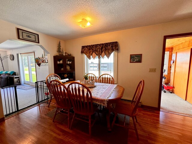 dining area featuring a textured ceiling and dark wood-type flooring