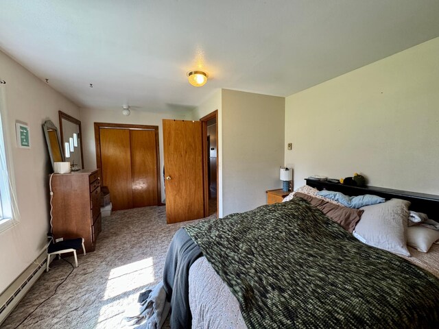 bedroom featuring a baseboard heating unit and carpet