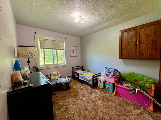 game room featuring a textured ceiling and carpet floors