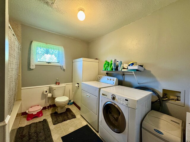 laundry area featuring washer and dryer and a textured ceiling