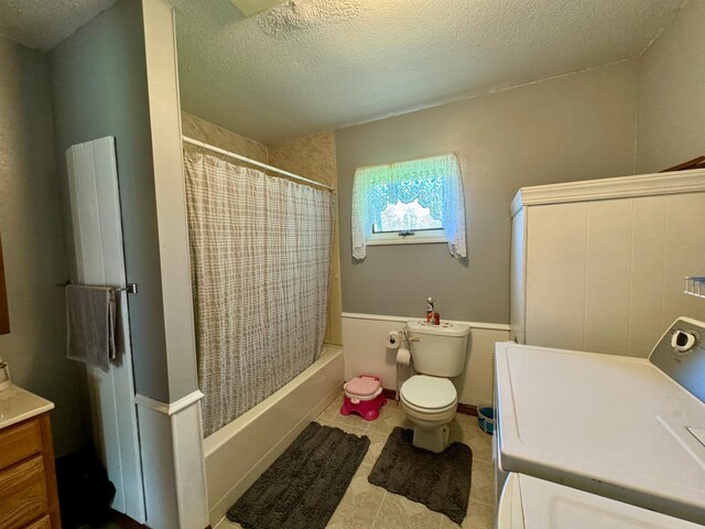 full bathroom featuring toilet, shower / tub combo, a textured ceiling, and vanity