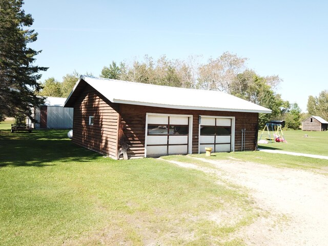 garage featuring a lawn