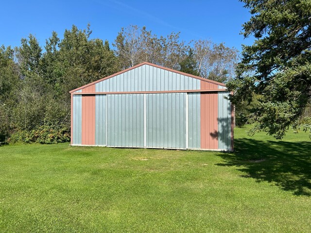 view of outbuilding featuring a lawn