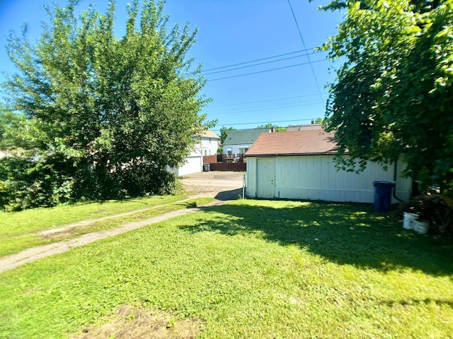 view of yard featuring a garage and an outdoor structure