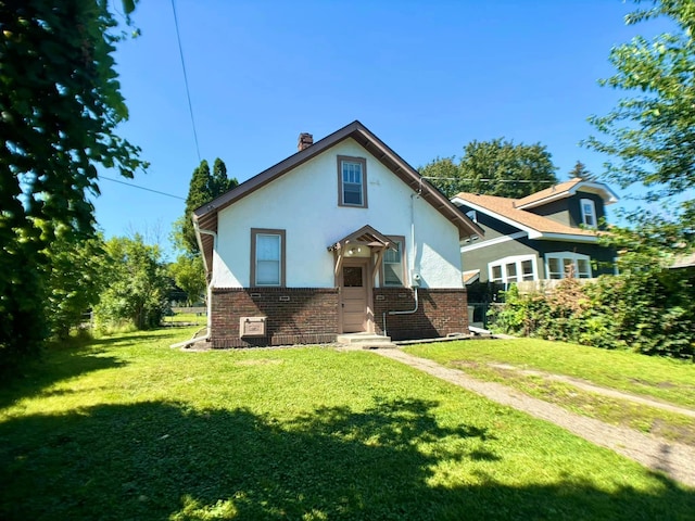 back of property featuring a lawn