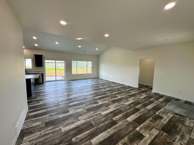 unfurnished living room featuring recessed lighting, dark wood-style flooring, and baseboards