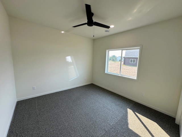 empty room with dark carpet, baseboards, a ceiling fan, and recessed lighting