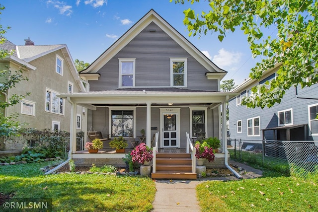 view of front of property featuring a front lawn and a porch