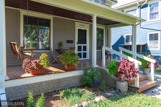 view of exterior entry with a porch