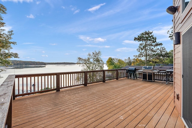 wooden terrace featuring a water view