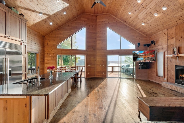 kitchen with wood ceiling, high vaulted ceiling, light wood-type flooring, and built in refrigerator