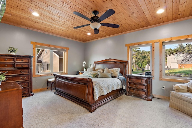 carpeted bedroom with wood ceiling, crown molding, multiple windows, and ceiling fan