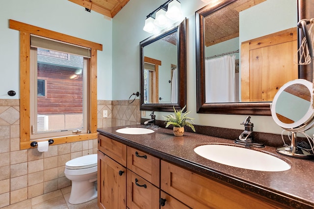 bathroom featuring tile walls, vanity, toilet, and tile patterned floors