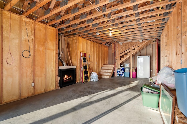 misc room with concrete flooring and a fireplace