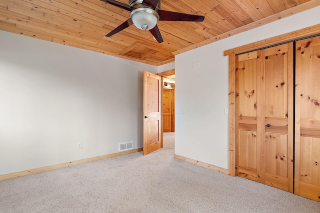 unfurnished bedroom featuring light carpet, wood ceiling, and ceiling fan