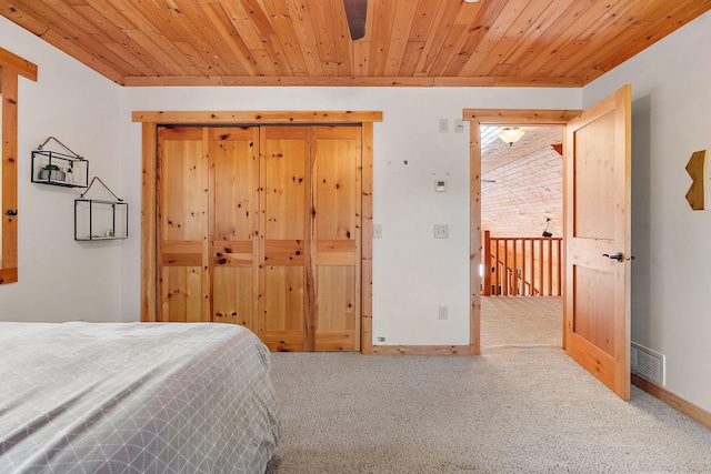 carpeted bedroom featuring wood ceiling