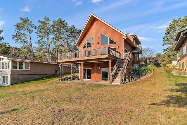 back of house featuring a deck and a lawn