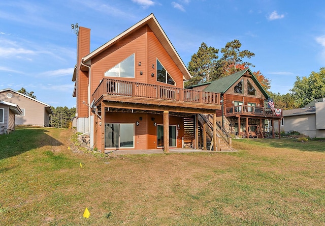 back of house featuring a deck and a lawn