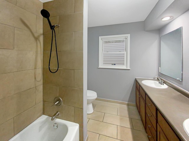 full bathroom featuring tile patterned floors, tiled shower / bath combo, vanity, and toilet