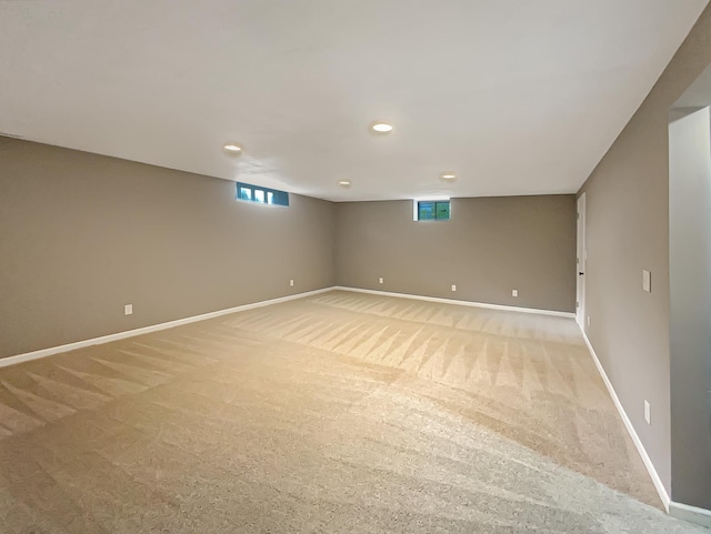 basement featuring light colored carpet