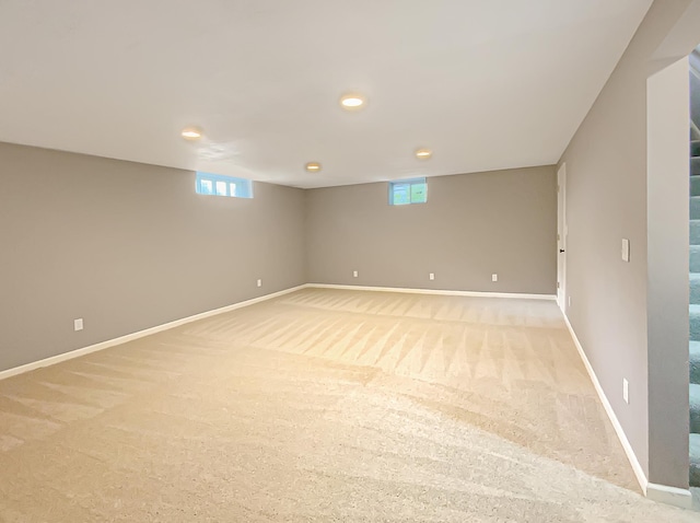 basement featuring light carpet