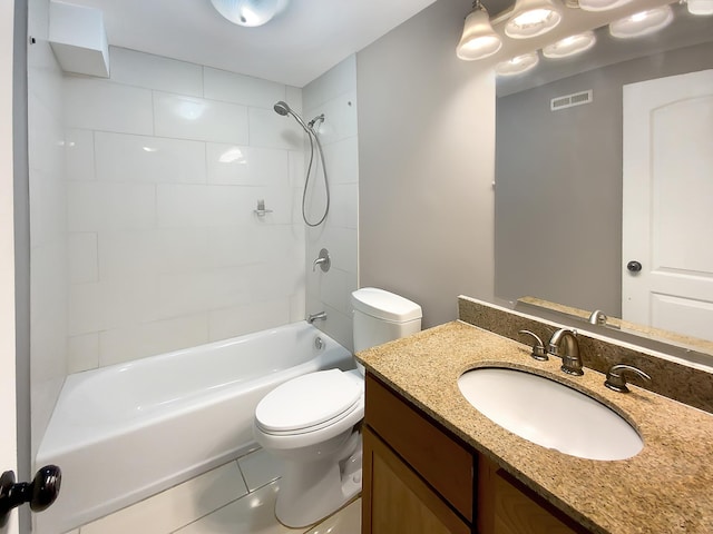 full bathroom featuring vanity, tiled shower / bath combo, toilet, and tile patterned floors