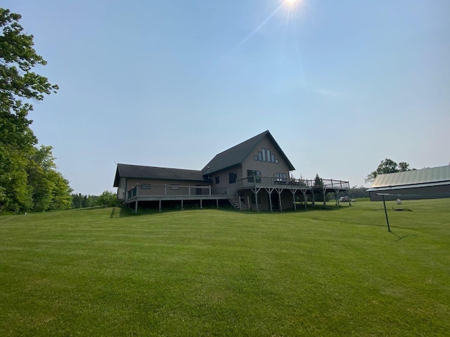 rear view of property featuring a yard and a deck