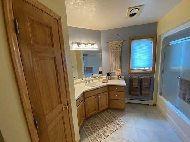 bathroom featuring baseboard heating, bath / shower combo with glass door, tile patterned floors, and vanity