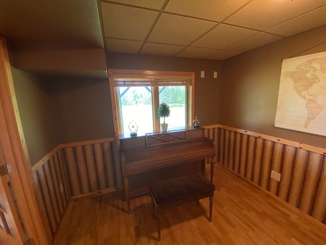 dining area featuring hardwood / wood-style flooring and a paneled ceiling