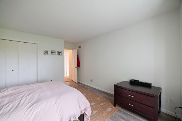 17661 Southridge Ct, Minnetonka, MN 55345 - bedroom with wood finished floors, baseboards, and a closet