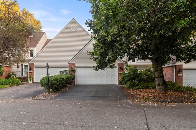 17661 Southridge Ct, Minnetonka, MN 55345 - view of front facade with brick siding and asphalt driveway