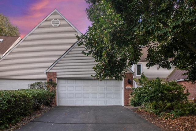 17661 Southridge Ct, Minnetonka, MN 55345 - view of front of property featuring brick siding, a garage, and asphalt driveway