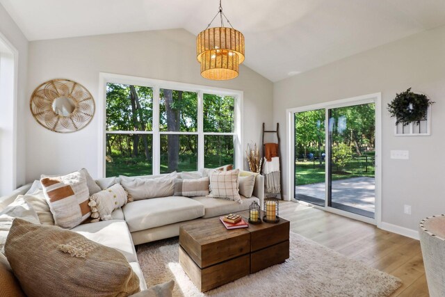 living room with light wood-type flooring and lofted ceiling