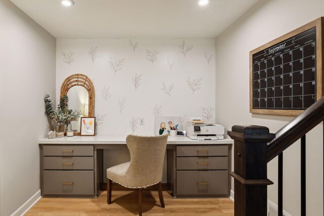 office space with light hardwood / wood-style flooring and built in desk