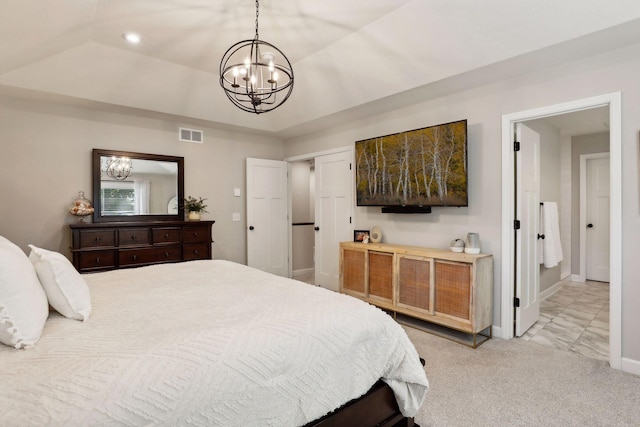 carpeted bedroom with an inviting chandelier