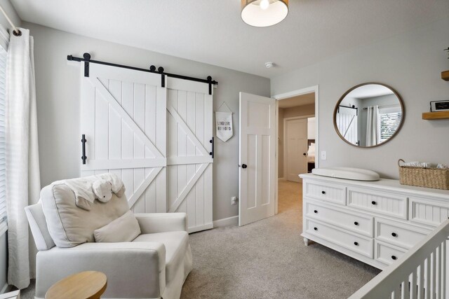 living area with a barn door and light colored carpet