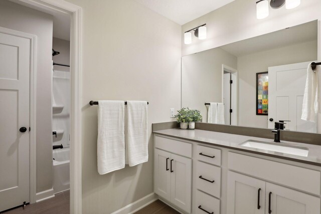 bathroom featuring independent shower and bath, vanity, and hardwood / wood-style flooring