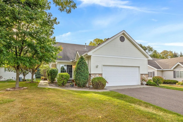 view of front of house featuring a garage and a front yard