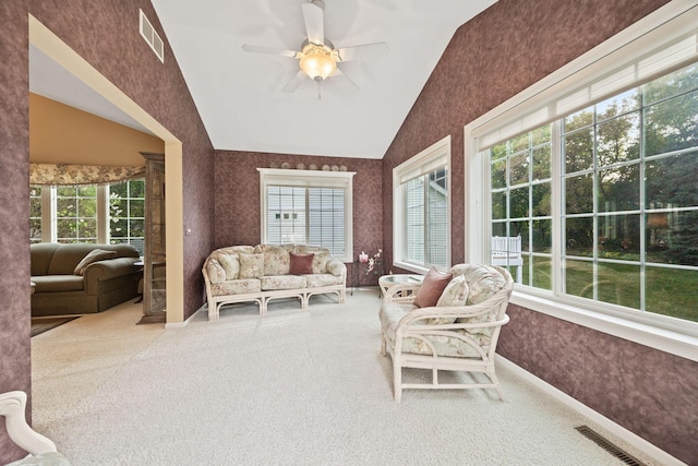 sunroom featuring ceiling fan, visible vents, and vaulted ceiling