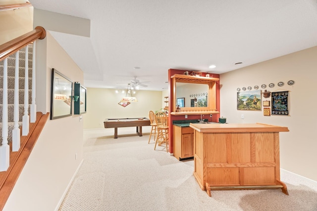 bar with stairs, wet bar, baseboards, and light colored carpet