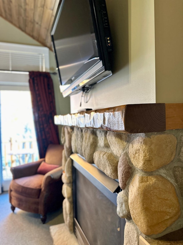 carpeted living area with lofted ceiling