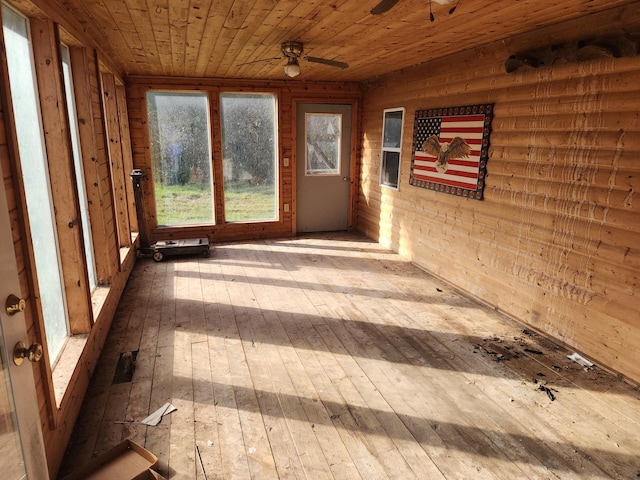 unfurnished sunroom with ceiling fan and wooden ceiling