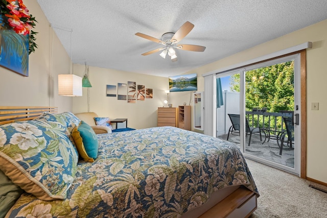 carpeted bedroom with visible vents, a textured ceiling, access to outside, and ceiling fan