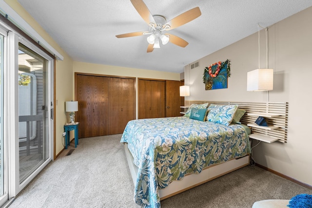 bedroom with access to exterior, visible vents, two closets, and carpet floors